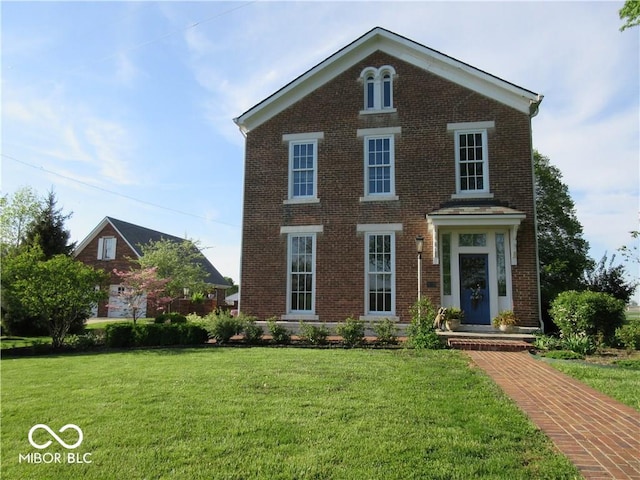 view of front of home featuring a front lawn and brick siding