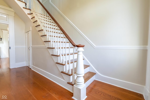 stairs with baseboards and wood finished floors