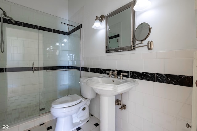 full bathroom with toilet, tile walls, and a stall shower