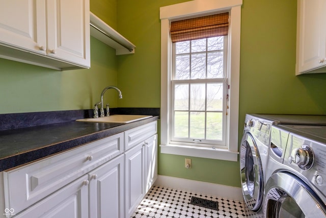 laundry room featuring baseboards, visible vents, washer and clothes dryer, cabinet space, and a sink