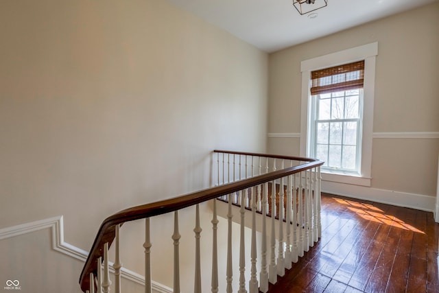 stairway featuring baseboards and hardwood / wood-style floors