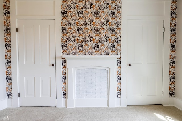 interior space with wallpapered walls and carpet floors