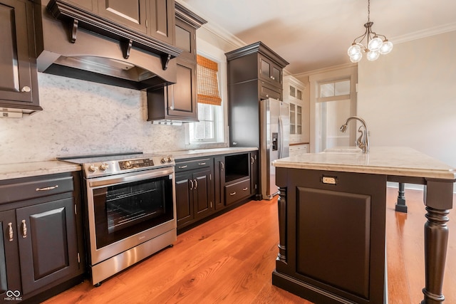 kitchen featuring crown molding, appliances with stainless steel finishes, under cabinet range hood, a sink, and backsplash