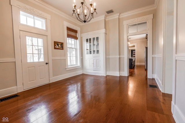 foyer featuring a chandelier and visible vents