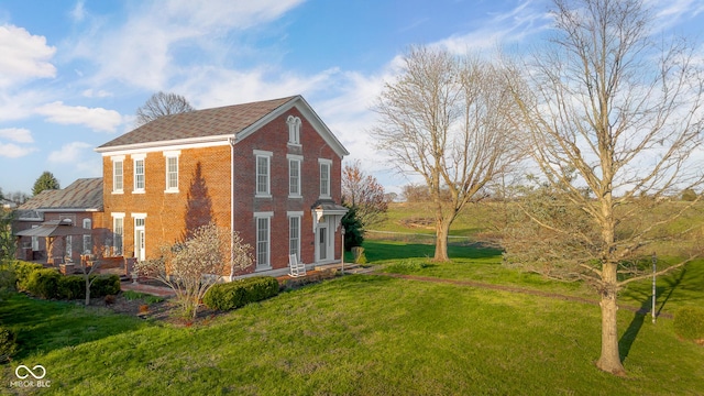 view of property exterior with a lawn and brick siding