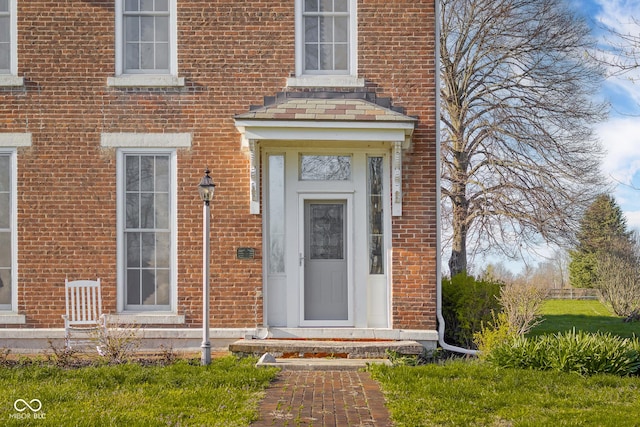 entrance to property with brick siding