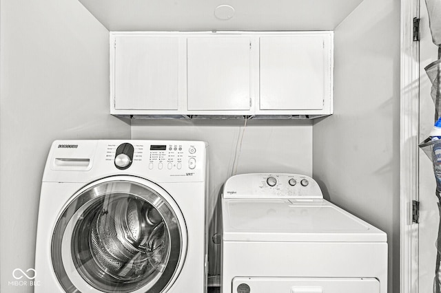 laundry area with cabinet space and washing machine and clothes dryer