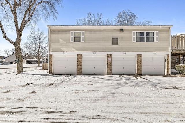 exterior space featuring a garage and brick siding