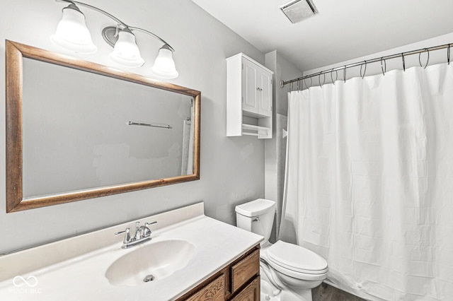 full bathroom with visible vents, vanity, and toilet