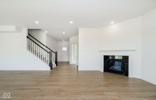 unfurnished living room with light hardwood / wood-style flooring