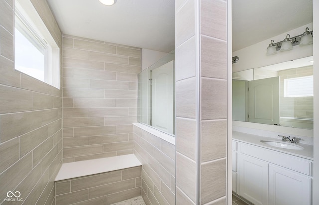 bathroom featuring vanity and a tile shower