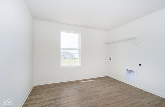 laundry room featuring hookup for a washing machine, hardwood / wood-style floors, and electric dryer hookup