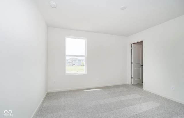 unfurnished room with light colored carpet