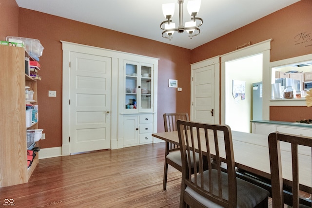 dining space with a notable chandelier and wood finished floors