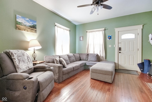 living area with light wood-style flooring and a ceiling fan