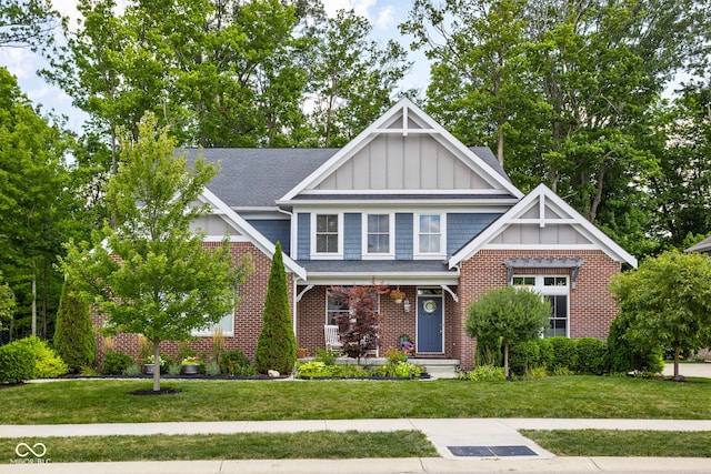 6504 W May Apple Dr, Mccordsville, IN 46055 - craftsman-style house featuring board and batten siding, a front lawn, a shingled roof, and brick siding