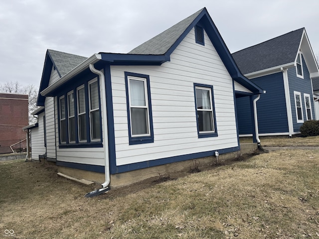 view of property exterior with a yard