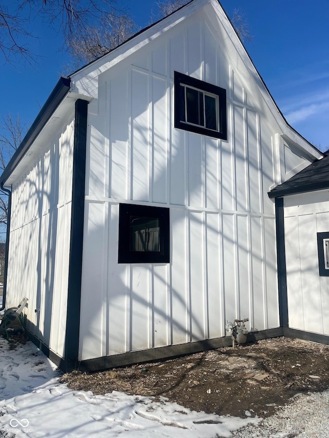 view of snow covered exterior featuring board and batten siding