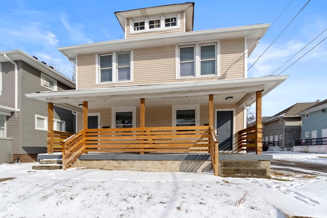 american foursquare style home featuring covered porch