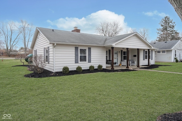 ranch-style home featuring roof with shingles, a chimney, and a front lawn