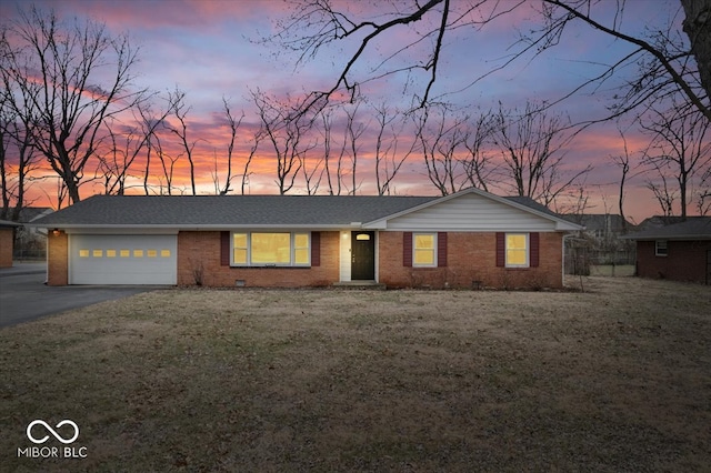 ranch-style house with a garage, brick siding, driveway, crawl space, and a front yard