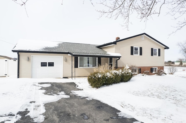 tri-level home featuring a garage and a chimney