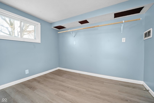 spacious closet featuring visible vents and light wood-style floors