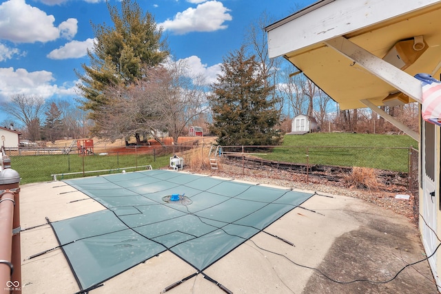 view of swimming pool with a patio area and a lawn