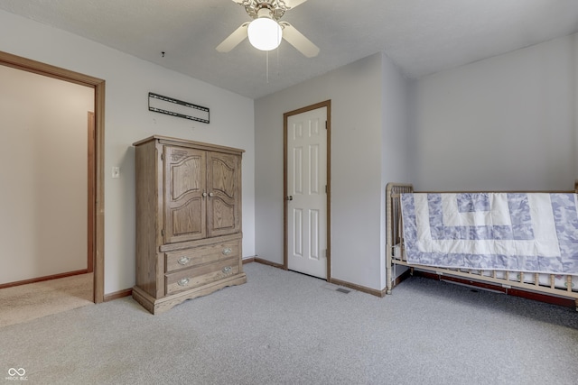 unfurnished bedroom featuring ceiling fan and light carpet