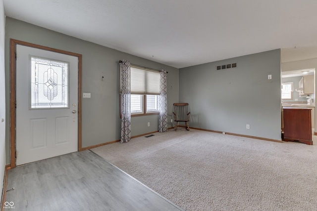 entrance foyer with light colored carpet