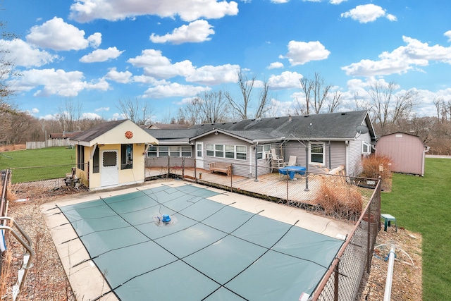 view of pool with a patio, a shed, and a lawn