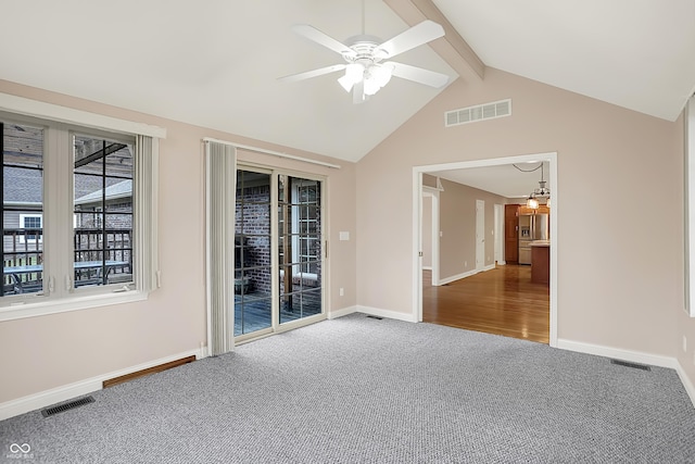 carpeted spare room featuring vaulted ceiling with beams, baseboards, and visible vents