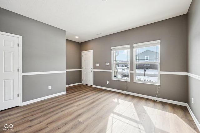 spare room with hardwood / wood-style floors