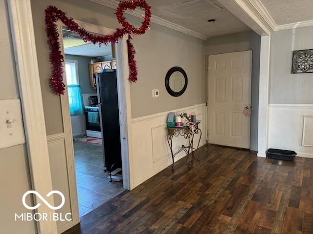 314 E Barachel Ln, Greensburg, IN 47240 - hall featuring dark wood-type flooring, a wainscoted wall, crown molding, and a decorative wall