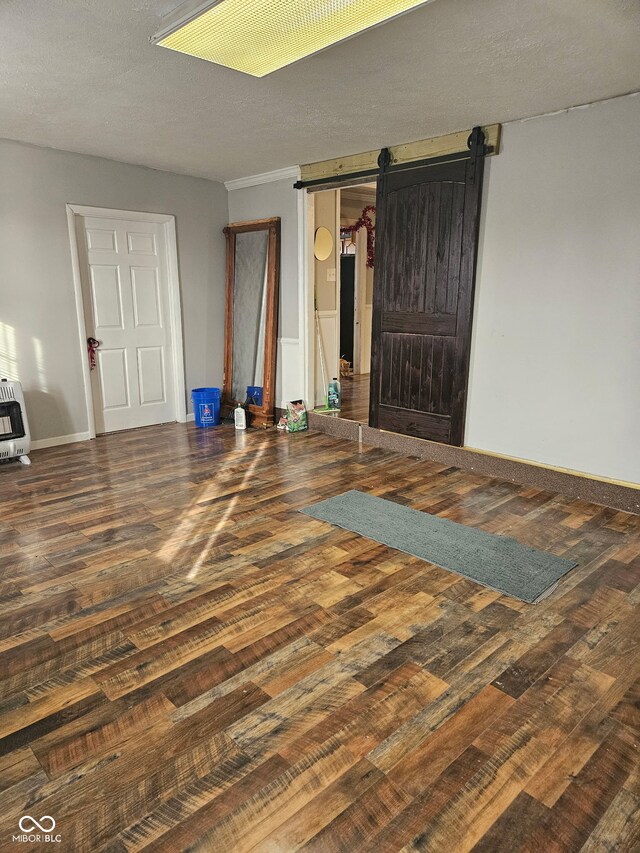 314 E Barachel Ln, Greensburg, IN 47240 - unfurnished bedroom featuring baseboards, a barn door, wood finished floors, and heating unit
