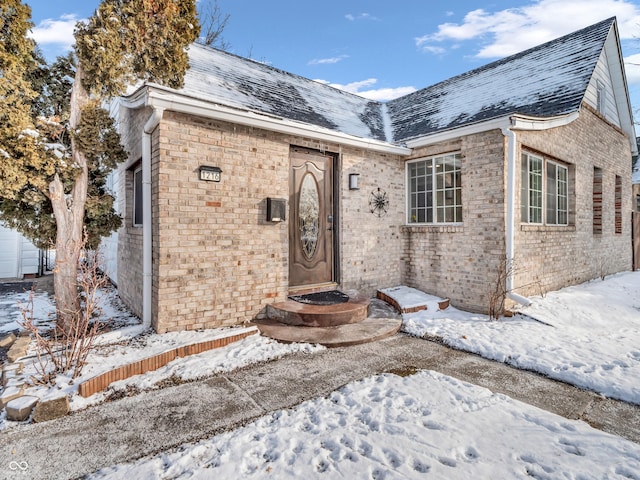 view of snow covered property entrance