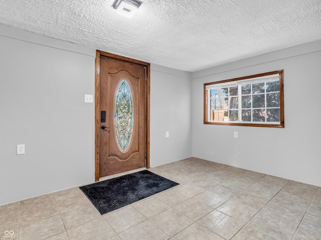 foyer with a textured ceiling