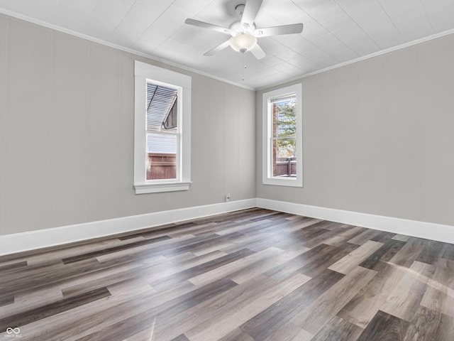 spare room with hardwood / wood-style floors, crown molding, and ceiling fan