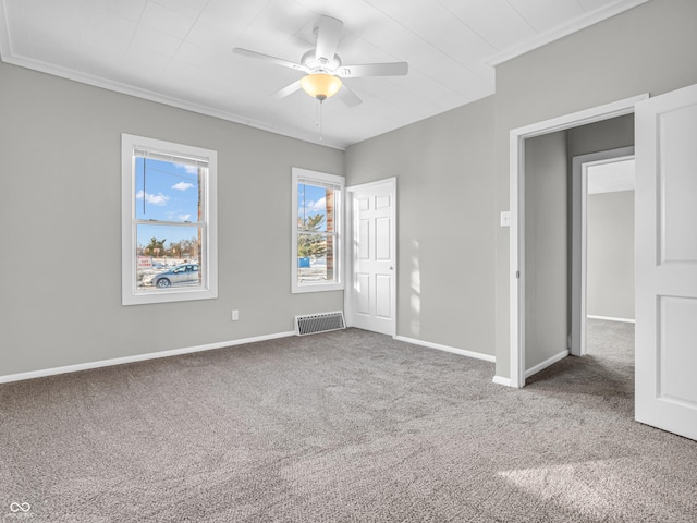 carpeted empty room featuring ornamental molding and ceiling fan