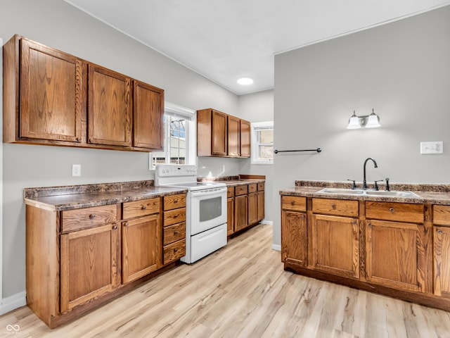 kitchen featuring light hardwood / wood-style flooring, sink, and white range with electric cooktop