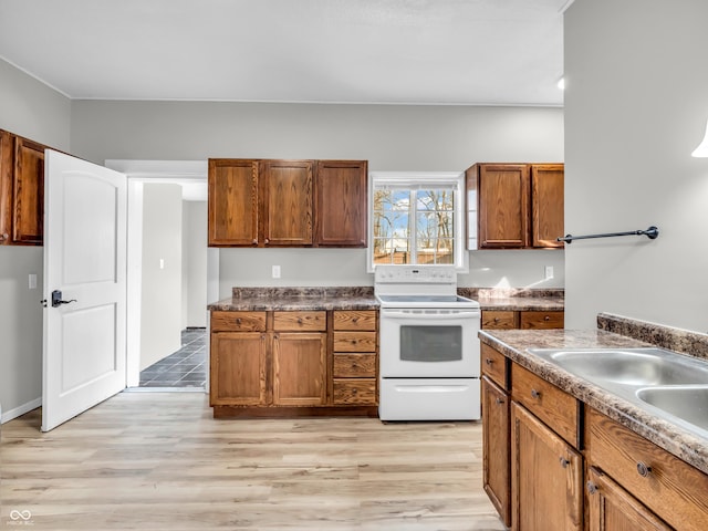 kitchen with sink, light hardwood / wood-style floors, and white electric range oven