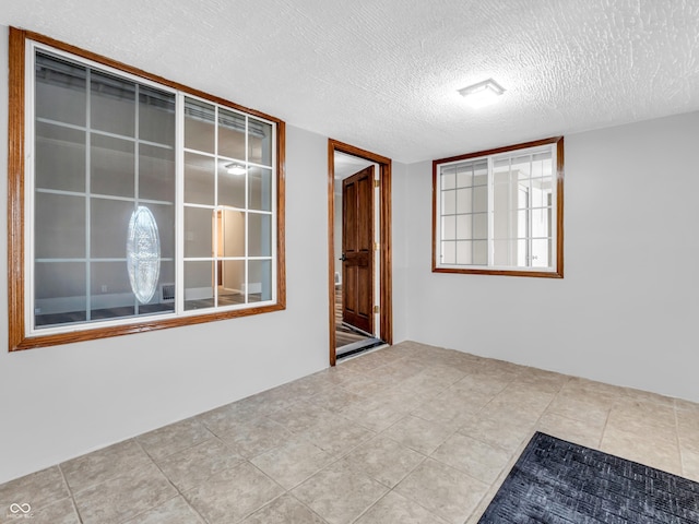 empty room featuring a textured ceiling