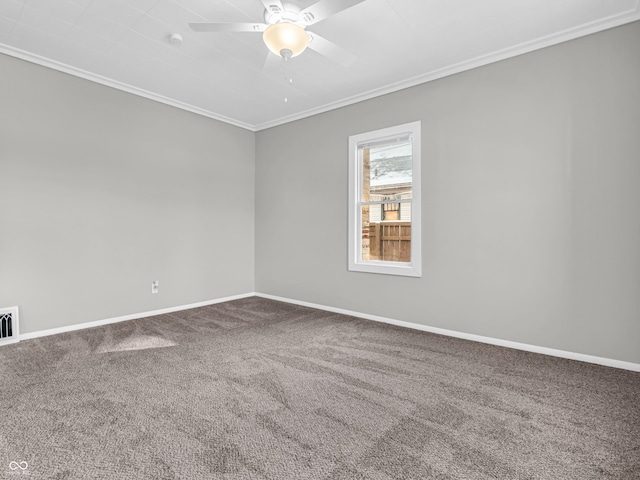 carpeted spare room with ceiling fan and ornamental molding