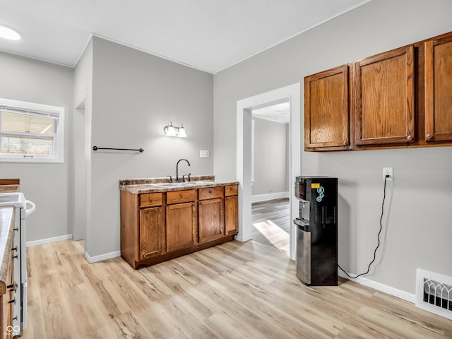 kitchen featuring sink and light wood-type flooring