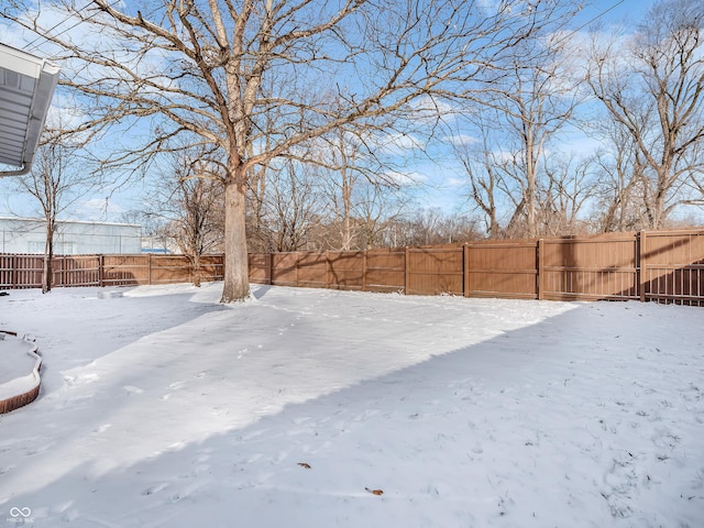 view of yard layered in snow