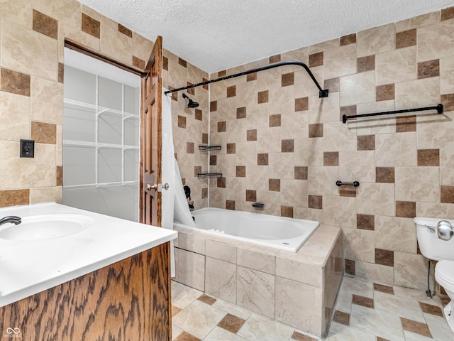 full bathroom featuring vanity, tile walls, a textured ceiling, and shower / tub combo