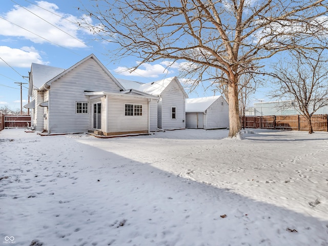 view of snow covered rear of property