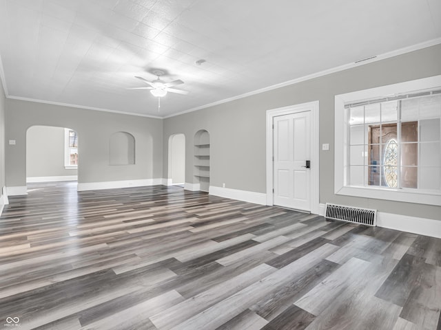 unfurnished living room featuring ornamental molding, ceiling fan, and wood-type flooring