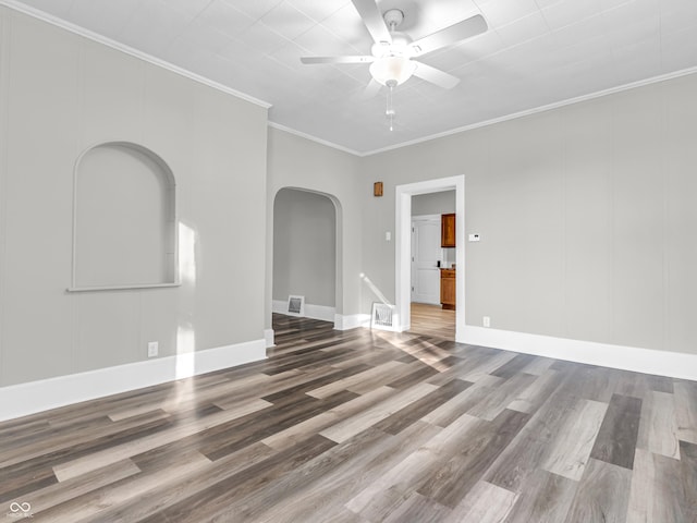 empty room featuring ornamental molding, hardwood / wood-style floors, and ceiling fan