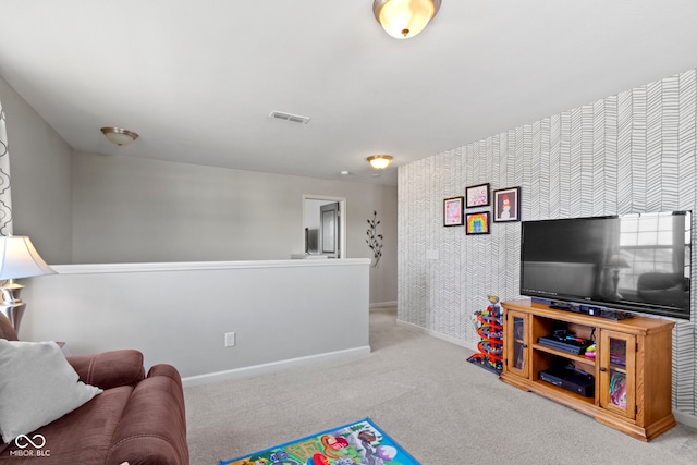 carpeted living room with visible vents and baseboards